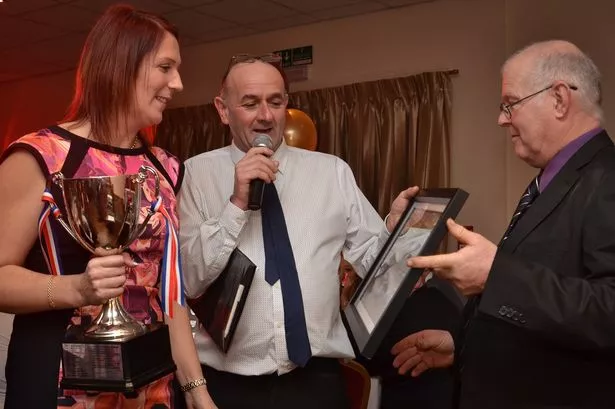 Michelle Arnett recieves her Yorkshire Dales AC champion’s trophy from Don Hilton (centre) and Roger Gill