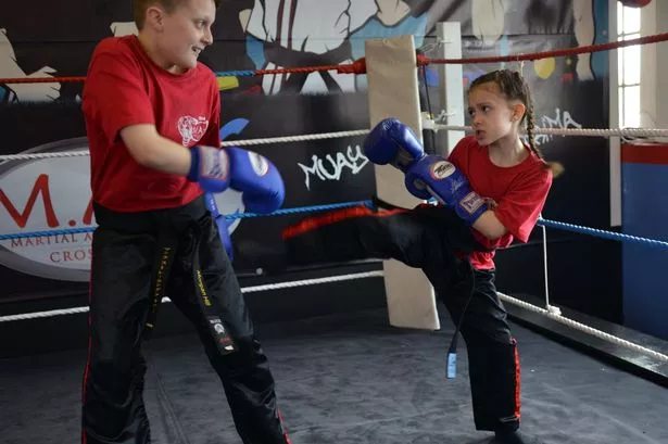 Saran Hill, 7, who has achieved black belt in MMA - a year younger than her brother Morgan (pictured) managed it