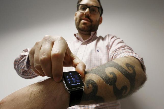  journalist Matt Siegel inputs his passcode onto his Apple Watch as his tattoos prevent the device's sensors from correctly detecting his skin, in Sydney, Australia, April 30, 2015. REUTERS/Jason Reed