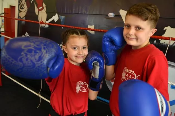 Saran Hill, 7, who has achieved black belt in MMA - a year younger than her brother Morgan (pictured) managed it. She is also British and European champion. Training here at MAX gym, Bright Street, Middlesbrough