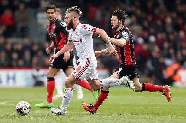 Adam Clayton of Middlesbrough holds off pressure from Marc Pugh of Bournemouth