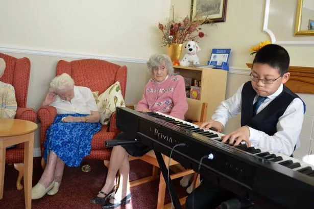 James Chen, 11, playing the piano for residents