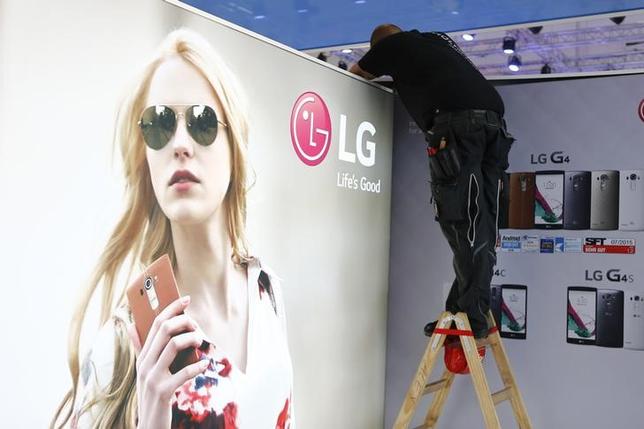 A worker makes adjustments at the booth of LG company at the IFA Electronics show in Berlin, Germany, September 2, 2015. REUTERS/Axel Schmidt