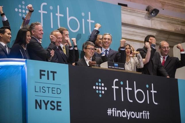 James Park (C), Fitbit CEO, stands as company officials applaud after ringing the opening bell on the day of the company's IPO above the floor of the New York Stock Exchange, June 18, 2015. REUTERS/Lucas Jackson