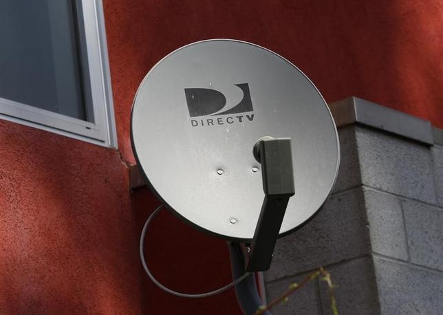A DirecTV satellite dish is seen on an apartment wall in Los Angeles, California May 18, 2014. REUTERS/Jonathan Alcorn