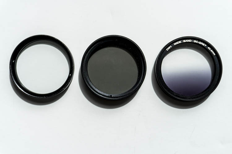 From left to right: A clear UV filter, a polarizing filter, and a Graduated Neutral Density filter.