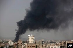 FILE - Smoke rises after Saudi-led airstrikes hit a food factory in Sana
