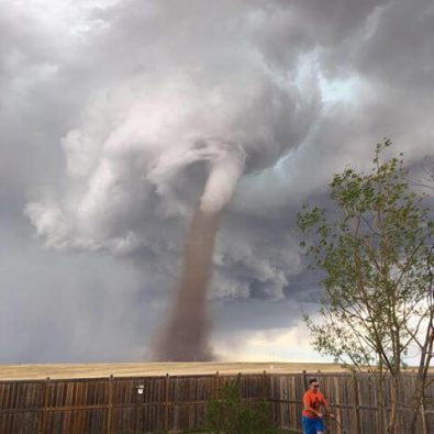 Canadian man mowing lawn is entirely not arsed by massive tornado behind him