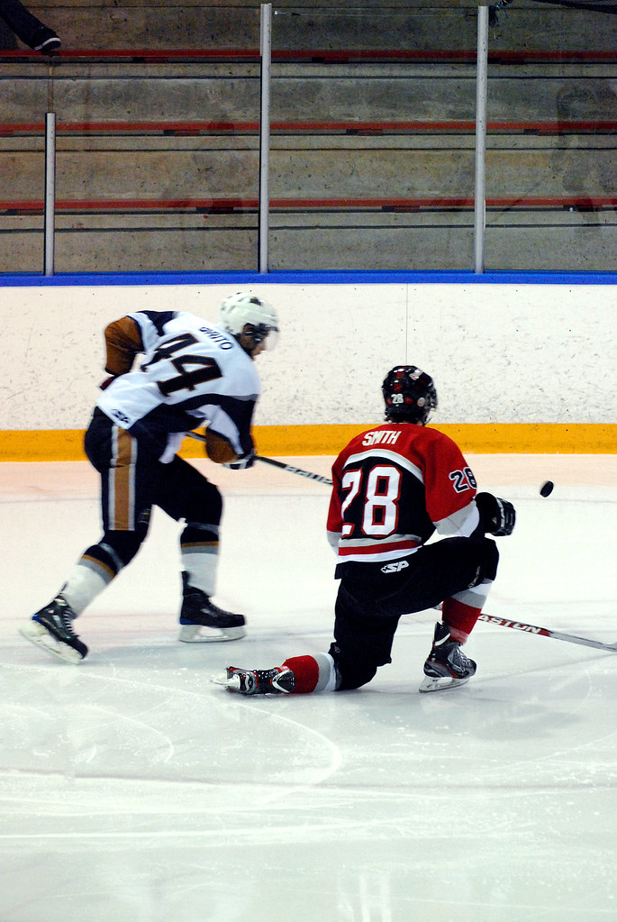 Richmond Sockeye #28 Dylan Smith takes a knee as Delta Ice Hawk #44 Anthony Brito chases the puck