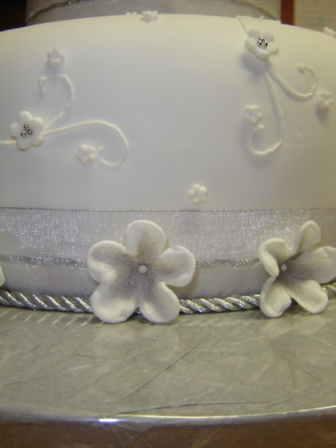 side view of silver floral wedding cake