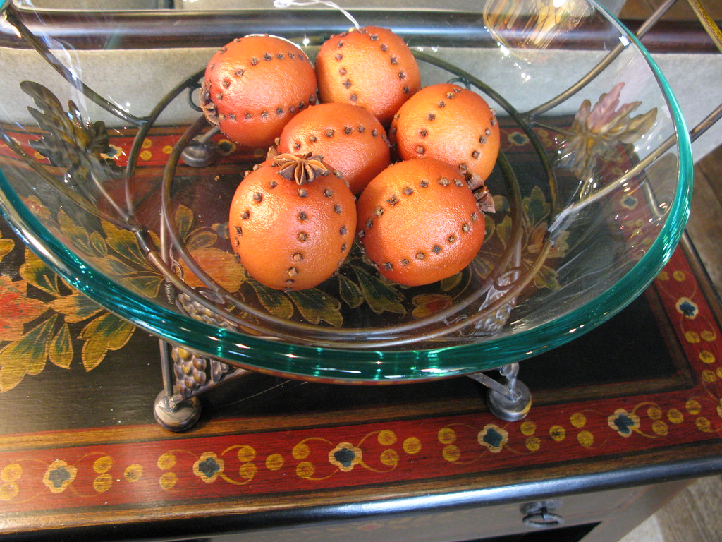 This Table is painted with a border in complementary colors.  A bowl of Orange Pomanders.
