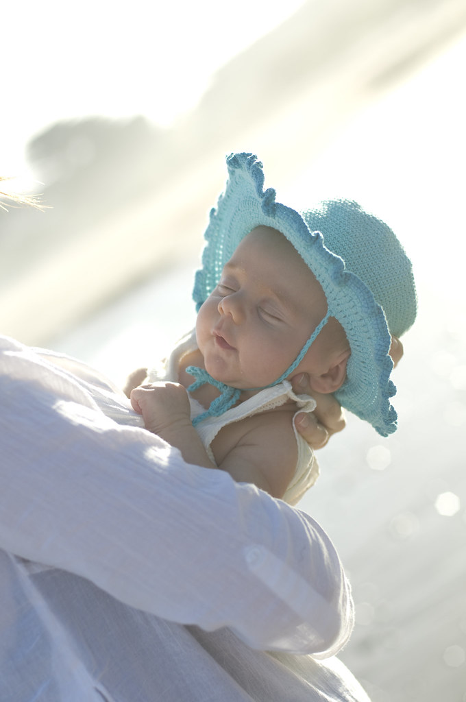 Baby in hat at beach