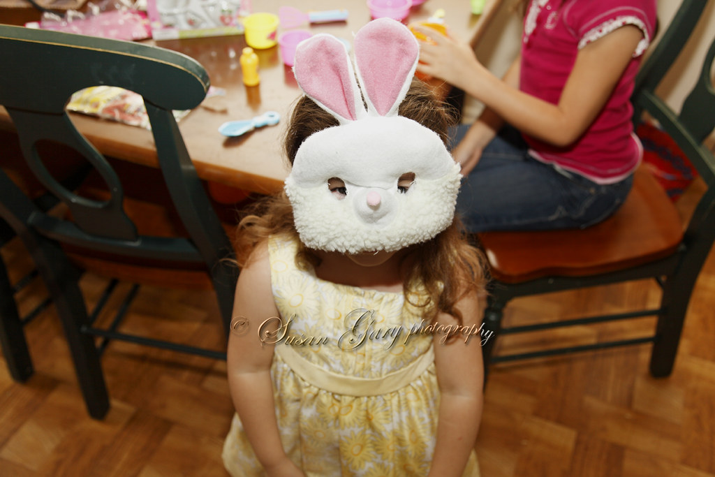 Toddler Girl in Bunny Mask Looking Up