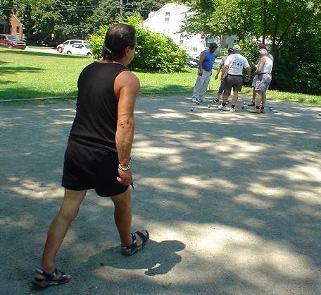 Roland walks up to the boules to see the layout