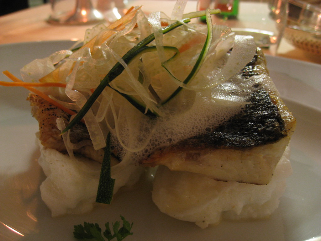Bass escalope on summer dressing, served with fish sauce and a spring bouquet of vegetables