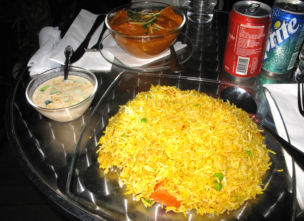 Tikka & Biryani - Vegetarian Zafran biryani and yogurt sauce, Aloo Gobi in the background