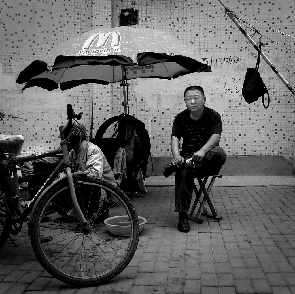 man with umbrella on sidewalk