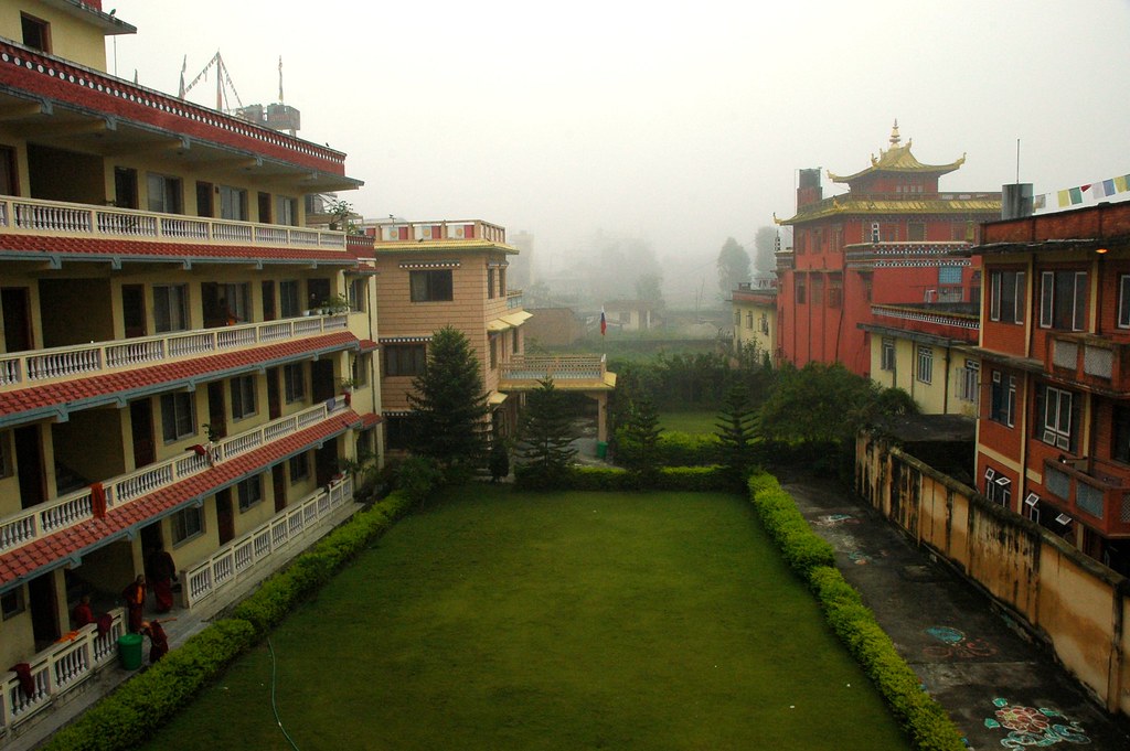 Cool mountain mists, monks quarters on the left, behind which is HE Dezhung Rinpoche's house,  view from the 3rd floor, Tharlam Monastery of Tibetan Buddhism, Boudha, Kathmandu, Nepal